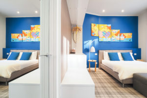 Room G Suite – bed details and exposed closet. Private bathroom door/mirror